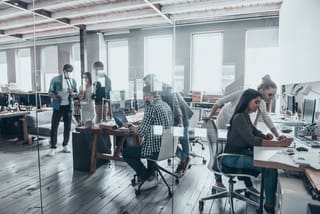 Successful team at work. Group of young business people working and communicating together in creative office